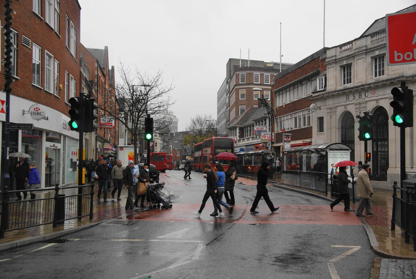 Shoppers crossing Eden Street in Kingston town centre