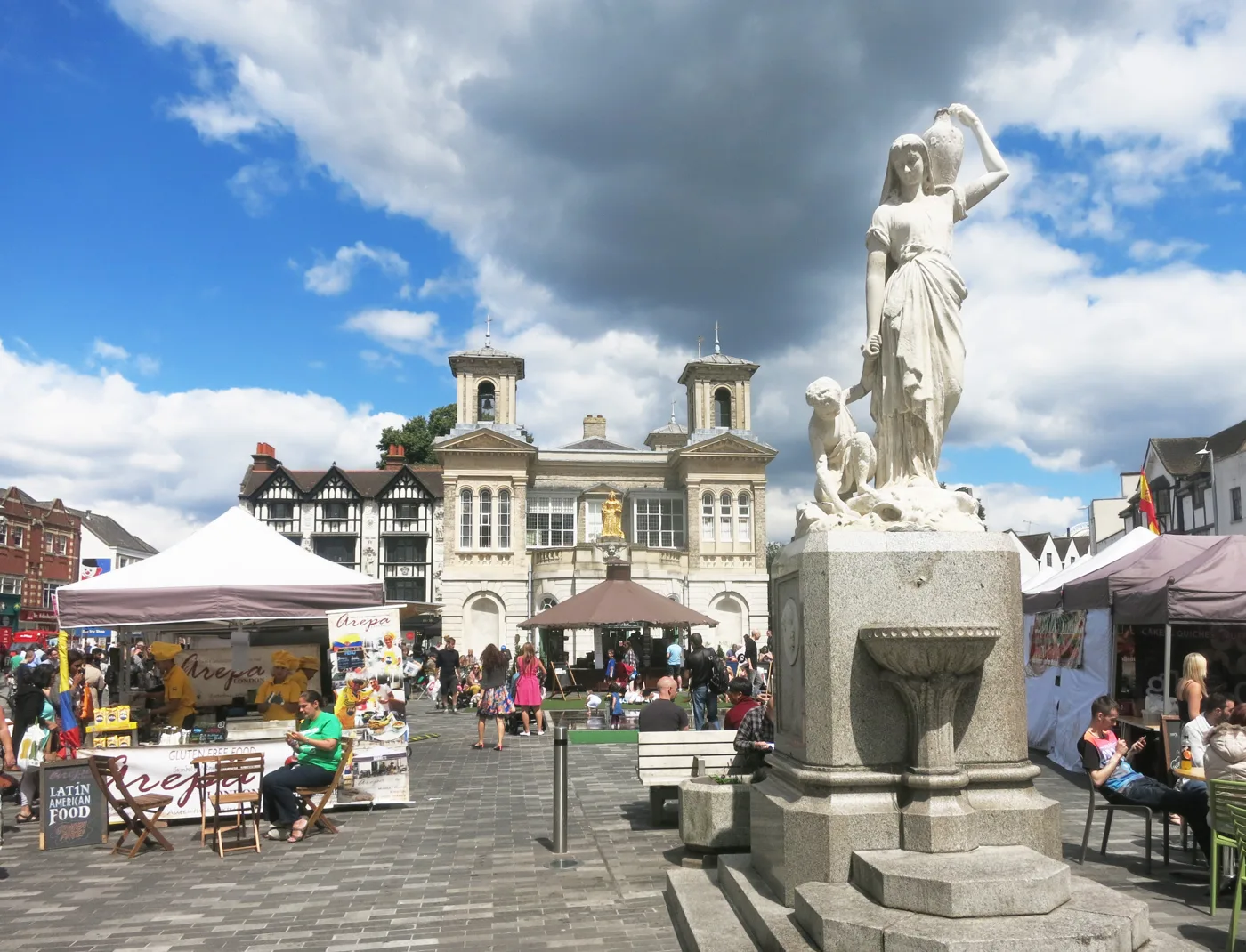 Market stalls in the Ancient Market Place, Kingston, with the Shrubsole Memorial and Market House. The picture shows the market before the fire.