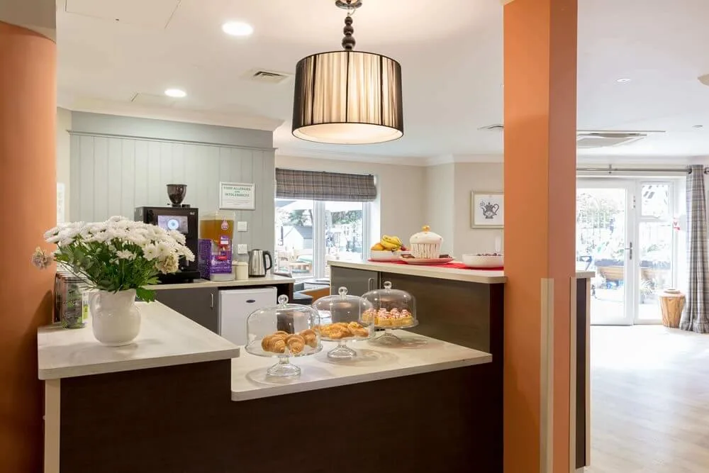 The café counter at Sherwood Grange, with cakes under glass domes and a coffee machine